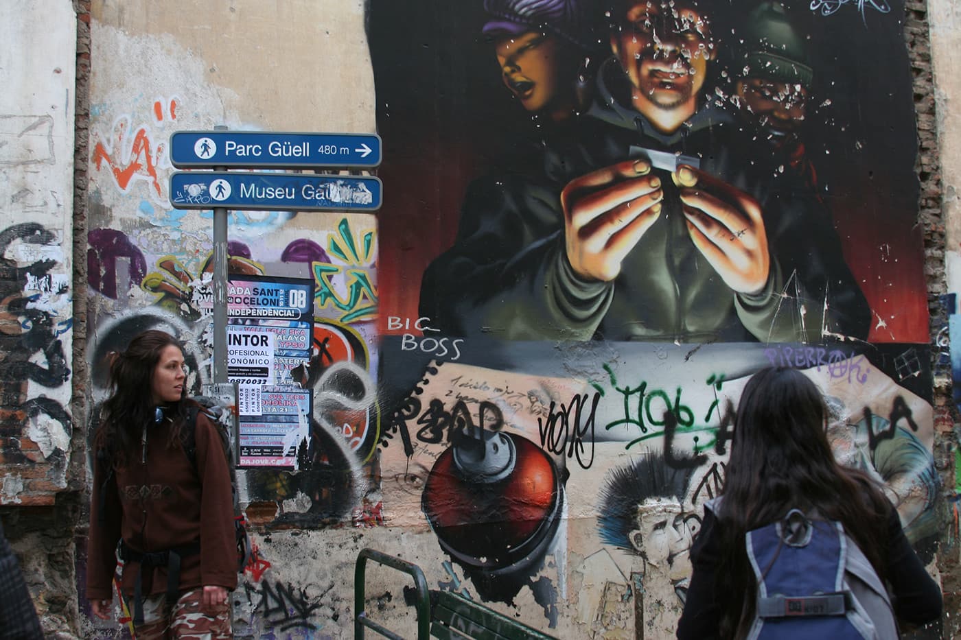 Scene near park Güell in Barcelona with a street stencil reading big boss and a couple of figures nearby