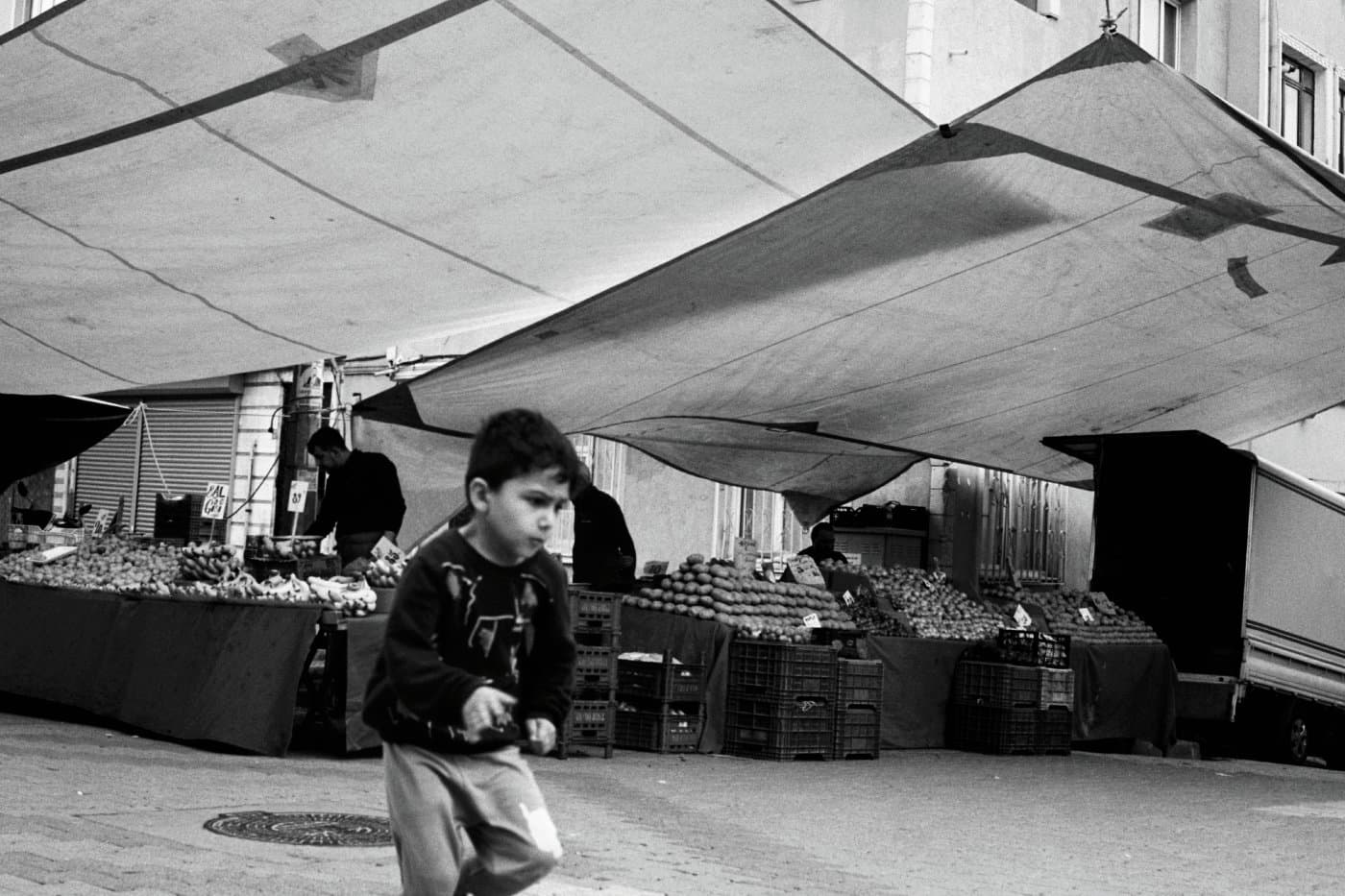 A boy running in an open street market