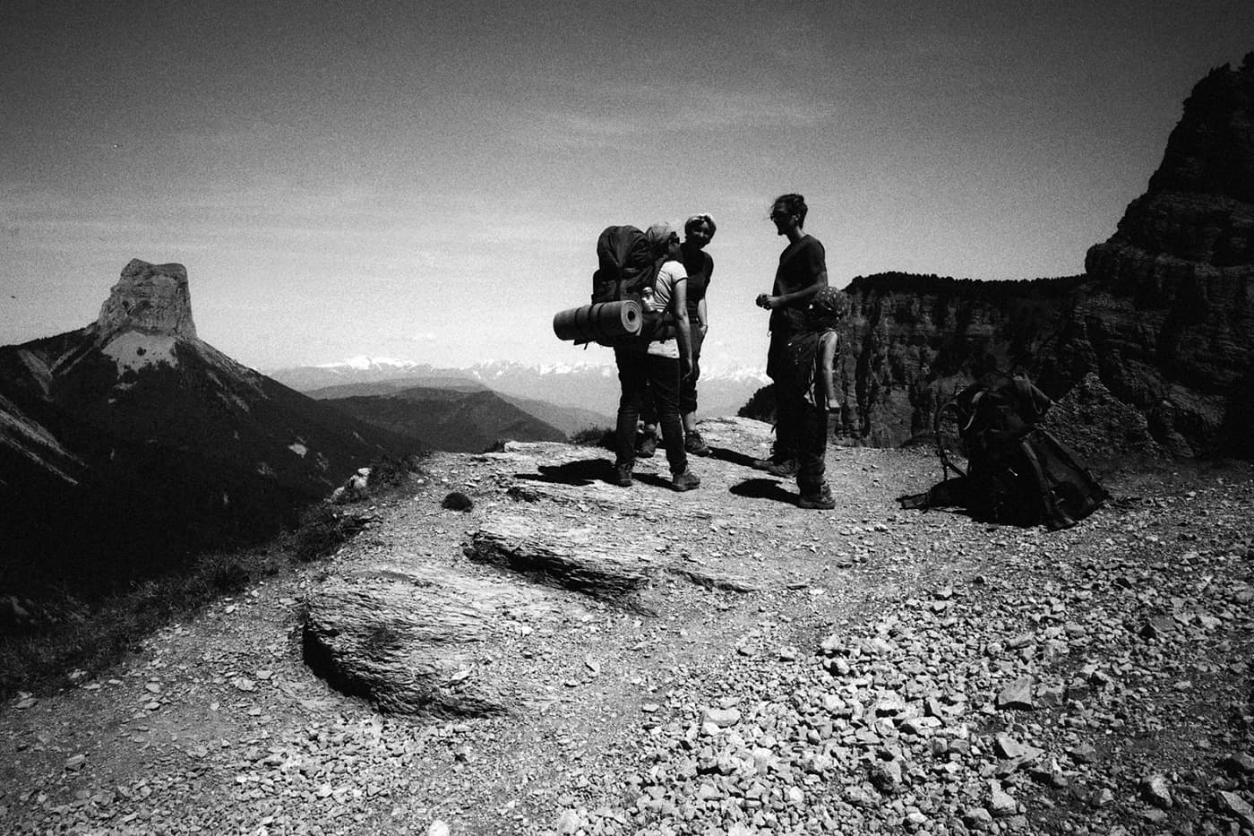 Hikers on a rocky edge - a mountain landscape with Mont Aiguille