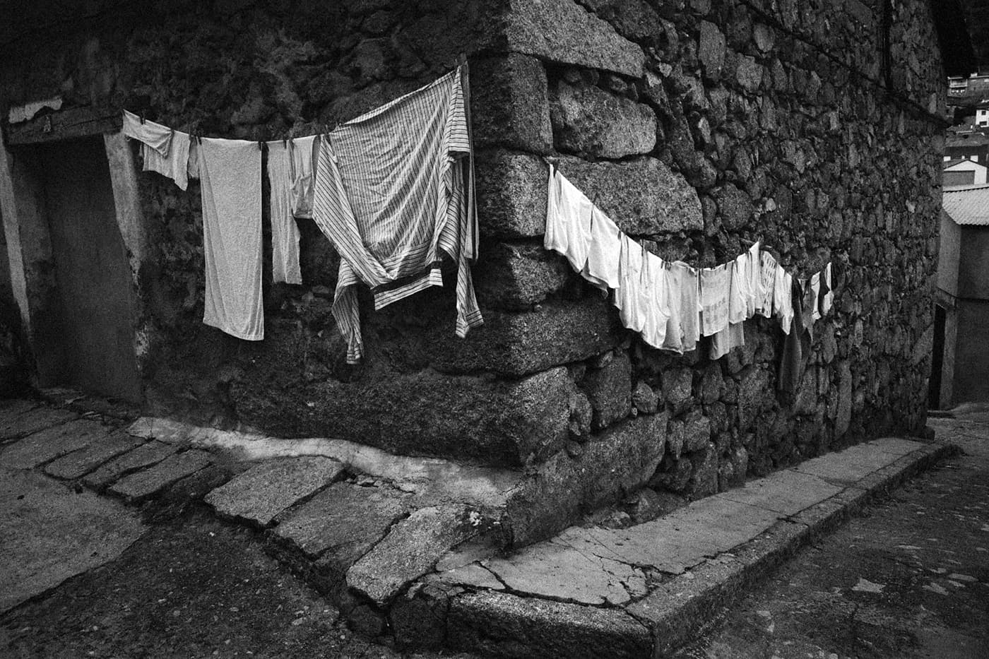 Clothes hanging to dry on the walls of a stone house